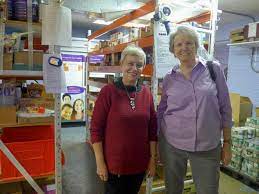Karen Dwyer (right) and Adelheid Thieme (left) packing food boxes in the St. Vincent de Paul Society’s pantry at Our Lady of Mt. Carmel Church. / Photo courtesy Adelheid Thieme