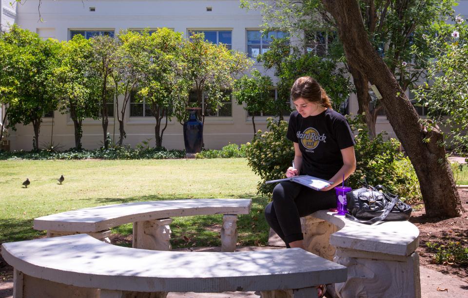 An ASU student spends quiet time in the Secret Garden. Photo by Charlie Leight/ASU.