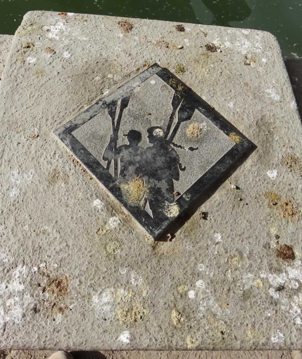 A granite tile at Tempe Town Lake featuring rowers Irena Praitis and Kristy Csavina has been visited many times by local birds. Photo by Karla Elling.
