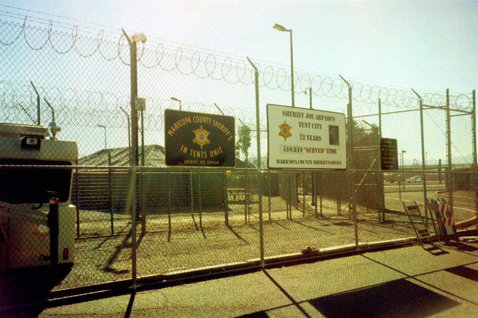 A sign fence at Maricopa County Sheriff Joe Arpaio's infamous "Tent City" in Arizona in 2016. Photo by ~filth~filler~ on Flickr. Used under CC 2.0.
