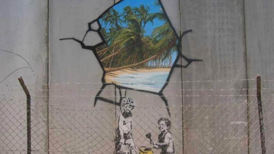 Banksy art graffiti at the Israeli West Bank barrier in Bethlehem / Photo by Markus Ortner from Wikimedia Commons