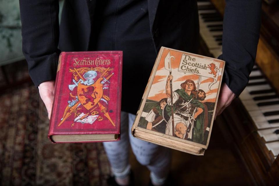 Devoney Looser holds two copies of Jane Porter's novel of William Wallace, The Scottish Chiefs. Photo by Deanna Dent/ASU.